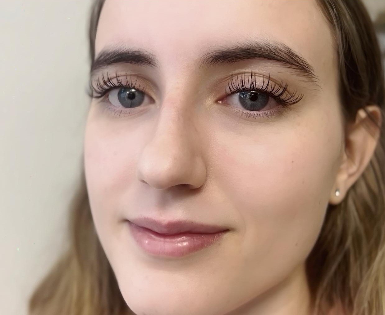 Close-up of classic single lash extensions on blue eyes at Ash's Lashes and Esthetics