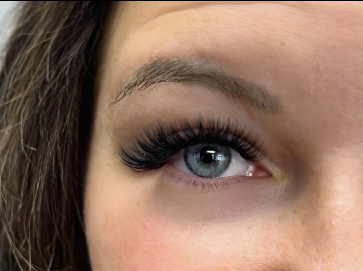 Close-up of volume lash extensions on blue eyes at Ash's Lashes and Esthetics
